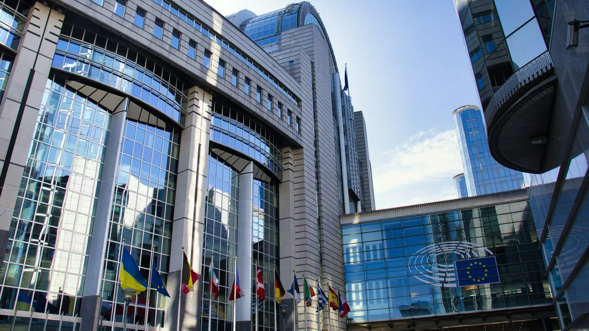 The European Parliament building with member-state flags.